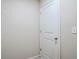 Interior view of a white door with silver hardware in a room with beige walls at 235 Orchard Dr, Covington, GA 30014