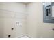 A laundry room with a wire shelf, hookups and an electrical panel at 235 Orchard Dr, Covington, GA 30014