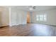 Bright, open living room features sleek wood floors, a modern ceiling fan and plenty of natural light at 235 Orchard Dr, Covington, GA 30014