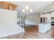 Open living space leading into kitchen with stainless steel appliances and granite countertops at 235 Orchard Dr, Covington, GA 30014