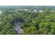 An aerial view showcasing the property's location within a dense, green tree canopy with a distant lake view at 6487 Northridge Way, Morrow, GA 30260