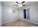 Bedroom featuring carpeted floors, a window with neutral curtains, and a ceiling fan at 6487 Northridge Way, Morrow, GA 30260