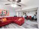 Open living area with red sectional sofa, modern art, and a dining area with seating for six at 6487 Northridge Way, Morrow, GA 30260