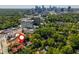 Aerial view showcases lush green surroundings near city skyline, highlighting its prime location at 8 Collier Nw Rd # B2, Atlanta, GA 30309