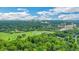 Expansive aerial view of a lush, green golf course and residential community, framed by trees, and the city skyline at 8 Collier Nw Rd # B2, Atlanta, GA 30309