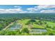 Breathtaking aerial view of lush green spaces with a golf course, tennis courts, and cityscape, showcasing recreational amenities at 8 Collier Nw Rd # B2, Atlanta, GA 30309