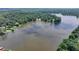 Beautiful aerial view of a scenic lake surrounded by lush green trees and waterfront properties at 8805 Lake Dr, Snellville, GA 30039