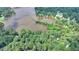 Aerial view capturing the home's lakefront setting with lush greenery and mature trees at 8805 Lake Dr, Snellville, GA 30039