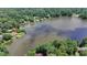 Scenic aerial showcasing a lake with waterfront homes nestled among lush, green trees at 8805 Lake Dr, Snellville, GA 30039