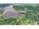 Expansive aerial view of a picturesque lake surrounded by lush green trees and waterfront homes at 8805 Lake Dr, Snellville, GA 30039