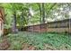 Fenced backyard features lush greenery and mature trees, offering a private outdoor space at 8805 Lake Dr, Snellville, GA 30039