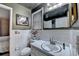 Bathroom featuring white tile, a mirror, a small window, and a vanity with a sink at 8805 Lake Dr, Snellville, GA 30039