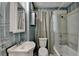 Bathroom shows blue striped walls, a vanity, a toilet, and a shower over tub at 8805 Lake Dr, Snellville, GA 30039