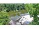 Scenic view of a community beach on the lake with docks, a sandy area, and picnic tables at 8805 Lake Dr, Snellville, GA 30039