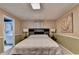 Comfortable bedroom featuring ample natural light, neutral color palette and hardwood floors at 8805 Lake Dr, Snellville, GA 30039