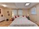 Bedroom showcases a neatly made bed with white linens, wood floors, and neutral walls at 8805 Lake Dr, Snellville, GA 30039