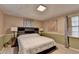Comfortable bedroom featuring ample natural light, neutral color palette and hardwood floors at 8805 Lake Dr, Snellville, GA 30039