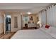 Bedroom featuring neutral walls and white linens, wood floors, and access to the bathroom at 8805 Lake Dr, Snellville, GA 30039