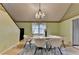 Light-filled dining room featuring modern table and chairs and a view of the staircase at 8805 Lake Dr, Snellville, GA 30039