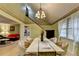 Light-filled dining room featuring modern table and chairs and chandelier at 8805 Lake Dr, Snellville, GA 30039
