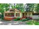 Charming home with a brick foundation, unique architecture, and a cozy screened porch at 8805 Lake Dr, Snellville, GA 30039