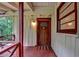Close-up of a quaint front porch featuring a rustic wooden door and traditional design at 8805 Lake Dr, Snellville, GA 30039