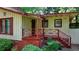 Inviting front porch with red wooden railings and brick foundation, leading to the entrance at 8805 Lake Dr, Snellville, GA 30039