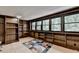 Home office with dark wood built-in bookshelves and lots of natural light from surrounding trees at 8805 Lake Dr, Snellville, GA 30039