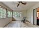 Screened patio featuring a rocking chair, rug, and outdoor views, perfect for relaxing and enjoying nature at 8805 Lake Dr, Snellville, GA 30039