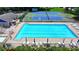 Inviting community pool with lounge chairs, umbrellas, and a tennis court nearby at 8805 Lake Dr, Snellville, GA 30039