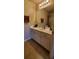 Bathroom vanity with white cabinets, laminate countertop, a large mirror and modern lighting at 1788 Arbor Gate Dr # 1505, Lawrenceville, GA 30044