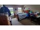 Bright bedroom with large windows and hardwood furniture at 1788 Arbor Gate Dr # 1505, Lawrenceville, GA 30044