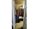 Walk-in closet is well-organized with a variety of clothing and personal items at 1788 Arbor Gate Dr # 1505, Lawrenceville, GA 30044