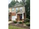 Charming townhome showcasing a brick facade, complemented by tidy landscaping and an attached garage at 1788 Arbor Gate Dr # 1505, Lawrenceville, GA 30044