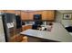 Contemporary kitchen with stainless steel appliances, wooden cabinets, and a convenient breakfast bar at 1788 Arbor Gate Dr # 1505, Lawrenceville, GA 30044