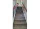 Carpeted staircase with decorative iron railings and wood accents leads to the upper level at 1788 Arbor Gate Dr # 1505, Lawrenceville, GA 30044