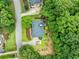 Stunning aerial view of the house surrounded by lush greenery and well-manicured landscaping at 205 Camden Creek Ct, Lawrenceville, GA 30043