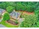 An aerial view of a lovely house surrounded by lush trees, showing landscaping, driveway and peaceful setting at 205 Camden Creek Ct, Lawrenceville, GA 30043
