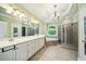 The spacious bathroom features dual sinks, a soaking tub, and a separate glass shower at 205 Camden Creek Ct, Lawrenceville, GA 30043