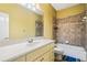 A bathroom features a tub, toilet, a sink, and tile; designed for functionality and style at 205 Camden Creek Ct, Lawrenceville, GA 30043