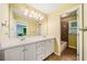 A well-lit bathroom features double sinks, a large mirror, and a separate tub/shower combination at 205 Camden Creek Ct, Lawrenceville, GA 30043