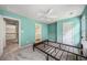 A bedroom with carpet, a ceiling fan, and several windows plus a doorway to a bathroom at 205 Camden Creek Ct, Lawrenceville, GA 30043