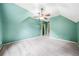 A spacious room with angled ceilings, a ceiling fan, carpet, and a window offers lots of light at 205 Camden Creek Ct, Lawrenceville, GA 30043