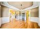 Formal dining room featuring hardwood floors, elegant chandelier, and stylish wainscoting at 205 Camden Creek Ct, Lawrenceville, GA 30043