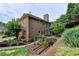 Charming home featuring brick and siding, complemented by a landscaped yard with garden beds, offering a serene outdoor space at 205 Camden Creek Ct, Lawrenceville, GA 30043