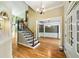 Elegant foyer showcasing hardwood floors, staircase with iron spindles, and views into the dining room at 205 Camden Creek Ct, Lawrenceville, GA 30043