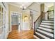 Elegant foyer showcasing hardwood floors, staircase with iron spindles, and views into the dining room at 205 Camden Creek Ct, Lawrenceville, GA 30043
