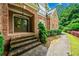 Charming brick home featuring a lovely front entrance with a walkway and manicured landscaping at 205 Camden Creek Ct, Lawrenceville, GA 30043