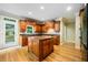 Bright kitchen with center island, wooden cabinets, stainless appliances, and natural light at 205 Camden Creek Ct, Lawrenceville, GA 30043