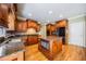 Beautiful kitchen boasts granite countertops, stainless steel appliances, hardwood floors, and ample storage at 205 Camden Creek Ct, Lawrenceville, GA 30043